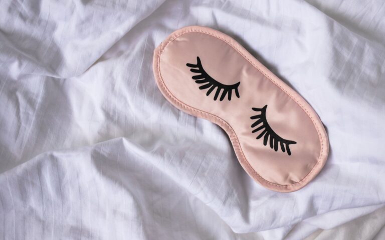 Eye mask on the bed sheet