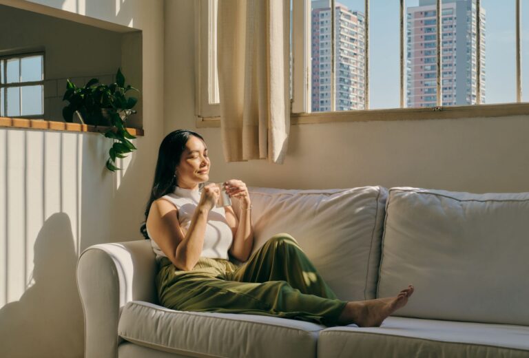 Person sitting on sofa practising mindfulness