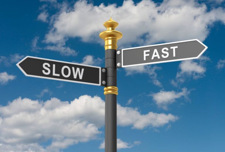 A sign pointing to slow and fast